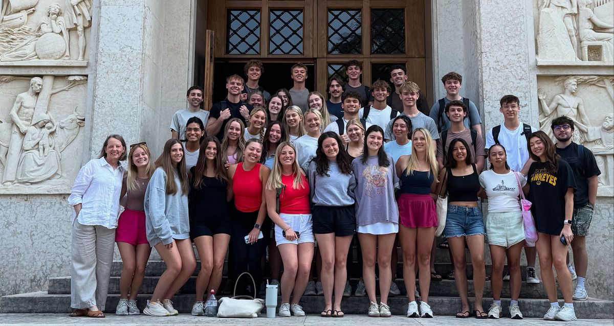A group of Summer 2025 CIMBA students and a professor posing on stone steps in Italy