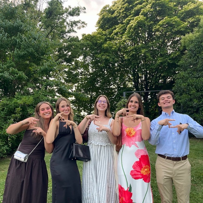 CIMBA students making the Arkansas hand sign together