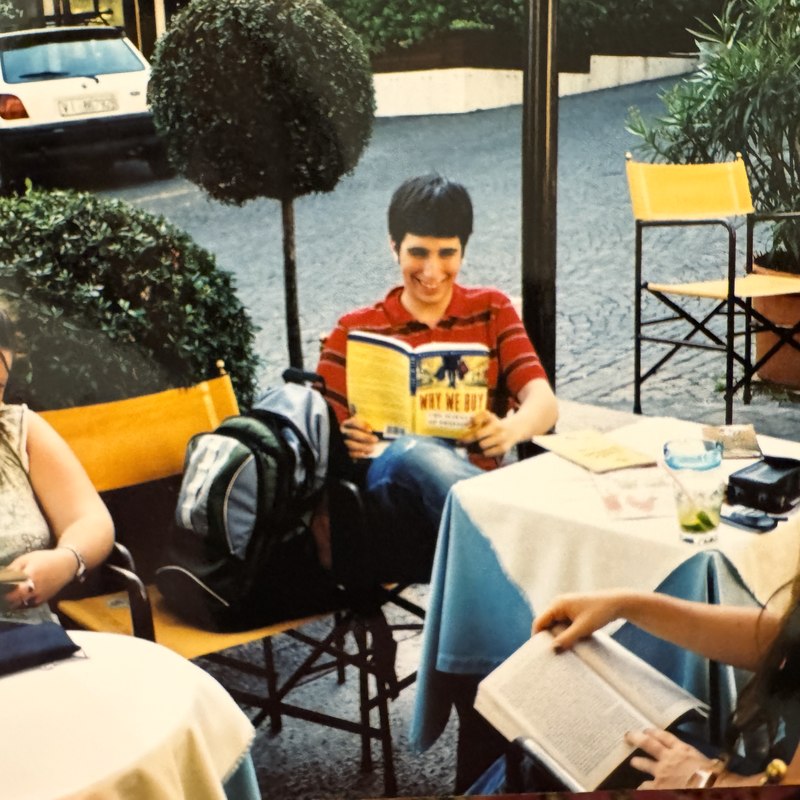 CIMBA student reading a marketing textbook at an Italian cafe