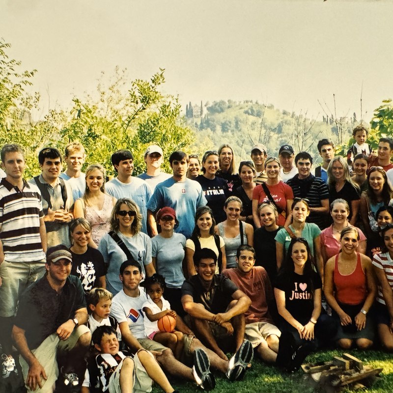 Large group of CIMBA students and staff on a hillside in Italy
